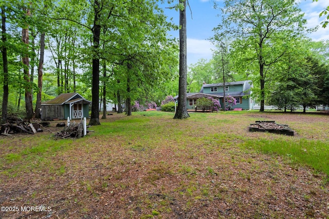 19 Kenyon Dr, Plumsted, NJ 08533 - view of grassy yard featuring an outbuilding and view of scattered trees