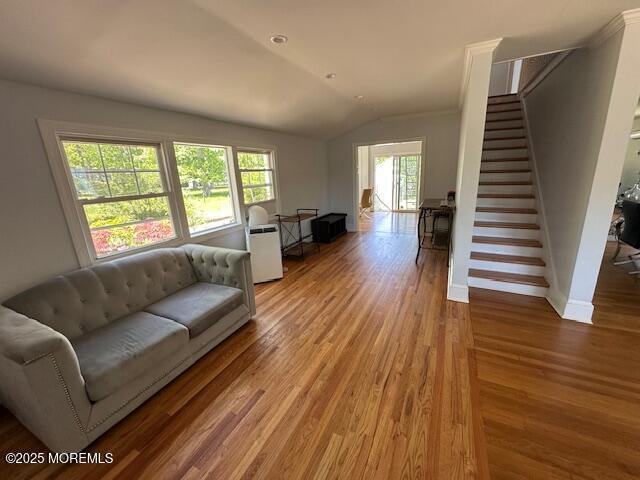 421 W Lincoln Ave, Oakhurst, NJ 07755 - living room with stairs, vaulted ceiling, wood finished floors, and baseboards