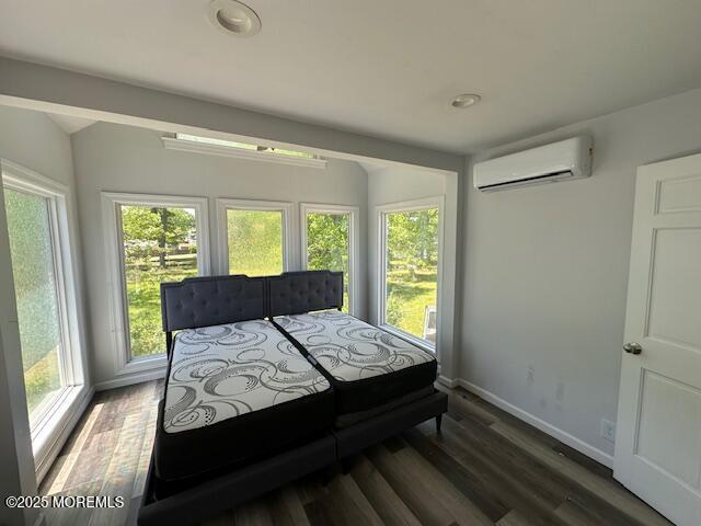 421 W Lincoln Ave, Oakhurst, NJ 07755 - bedroom featuring a wall mounted air conditioner, multiple windows, wood finished floors, baseboards, and lofted ceiling