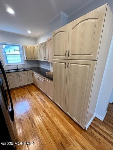 421 W Lincoln Ave, Oakhurst, NJ 07755 - kitchen featuring a sink, light wood-style flooring, dark countertops, crown molding, and recessed lighting