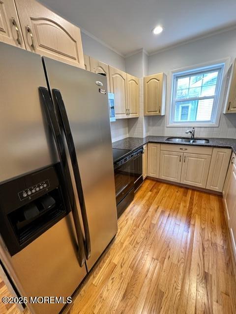 421 W Lincoln Ave, Oakhurst, NJ 07755 - kitchen featuring stainless steel refrigerator with ice dispenser, a sink, dark countertops, crown molding, and light wood-style floors