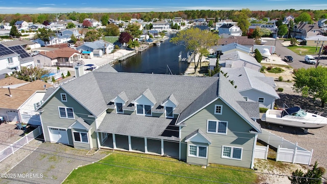 aerial perspective of suburban area with a nearby body of water