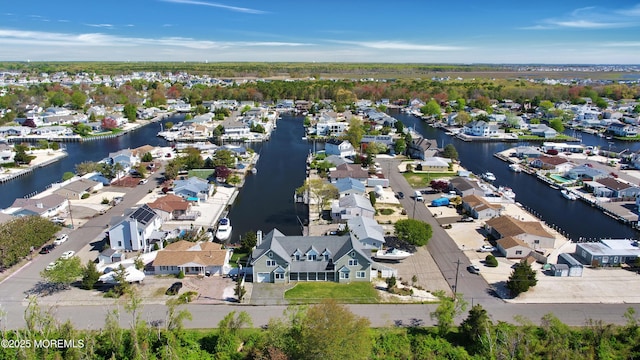 aerial view of property's location featuring nearby suburban area and a nearby body of water