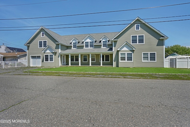 traditional home featuring a garage and covered porch