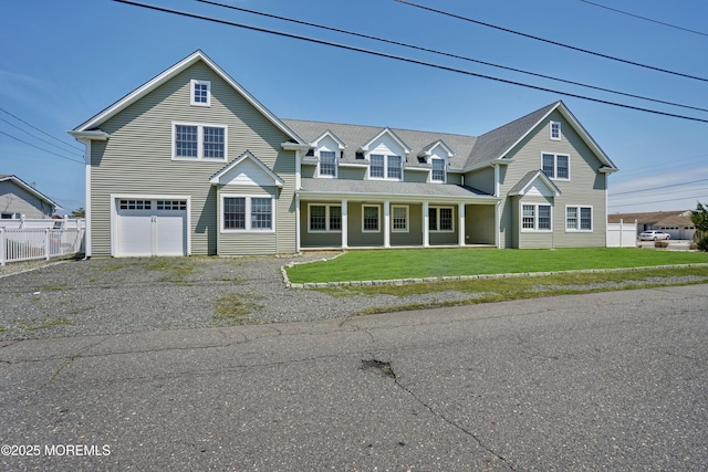 view of front of property featuring an attached garage, a porch, and driveway