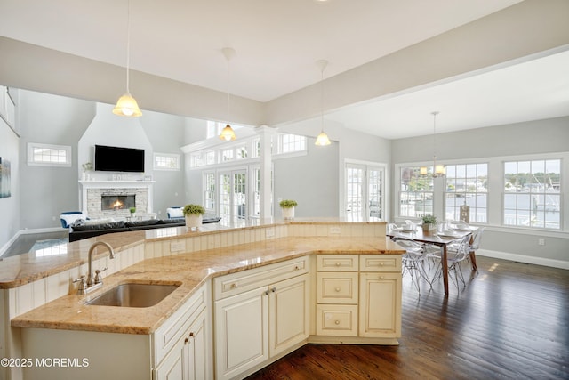kitchen with a sink, open floor plan, healthy amount of natural light, and a fireplace
