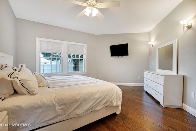 bedroom featuring baseboards, dark wood-style flooring, and ceiling fan