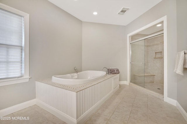 bathroom featuring a stall shower, a garden tub, tile patterned floors, baseboards, and recessed lighting