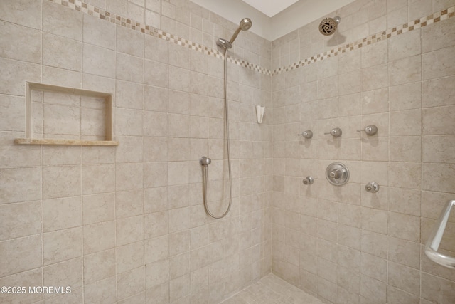 full bath with a tile shower