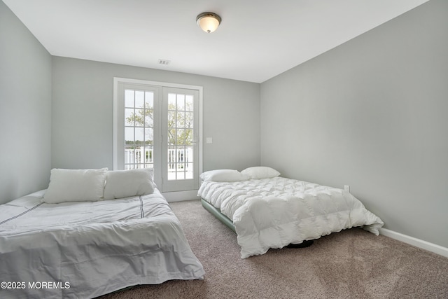 bedroom with carpet floors, access to exterior, and baseboards