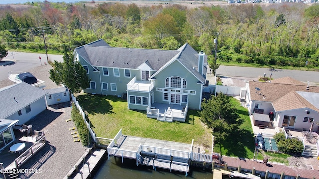 aerial view of property and surrounding area with a heavily wooded area