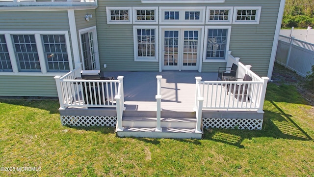 wooden terrace featuring a lawn