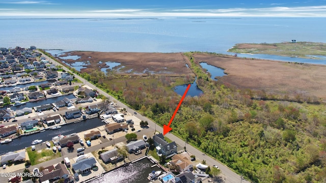 aerial overview of property's location featuring a large body of water and nearby suburban area