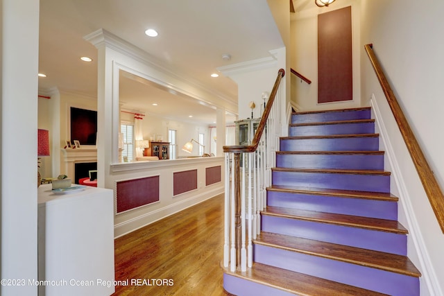 35 Embury Ave, Ocean Grove, NJ 07756 - stairway with ornamental molding, wood finished floors, a fireplace, and recessed lighting