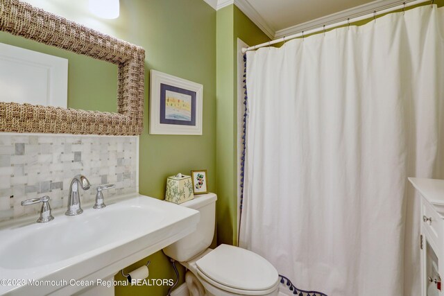 35 Embury Ave, Ocean Grove, NJ 07756 - bathroom with a sink, tasteful backsplash, toilet, ornamental molding, and curtained shower