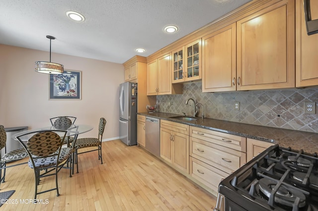 23 Woodpecker Way, Marlboro, NJ 07746 - kitchen with appliances with stainless steel finishes, decorative backsplash, light wood-style floors, glass insert cabinets, and recessed lighting