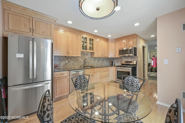 23 Woodpecker Way, Marlboro, NJ 07746 - kitchen with stainless steel appliances, light wood finished floors, light brown cabinets, tasteful backsplash, and recessed lighting