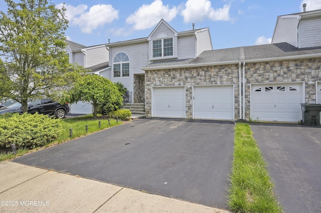 23 Woodpecker Way, Marlboro, NJ 07746 - view of property featuring stone siding, asphalt driveway, and an attached garage