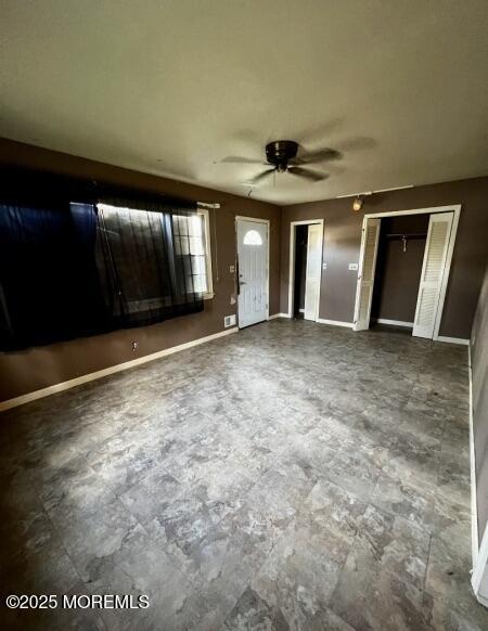 80 Seeley Ave, Keansburg, NJ 07734 - unfurnished bedroom featuring multiple closets, baseboards, and ceiling fan