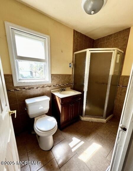 80 Seeley Ave, Keansburg, NJ 07734 - bathroom with tile walls, tile patterned flooring, a shower stall, vanity, and toilet