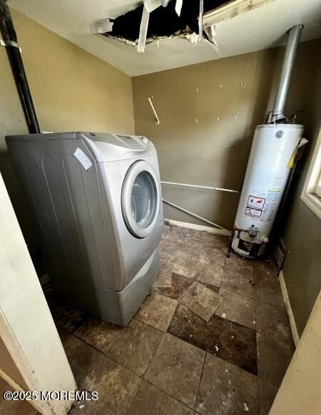 80 Seeley Ave, Keansburg, NJ 07734 - washroom featuring water heater, washer / clothes dryer, baseboards, and stone finish floors