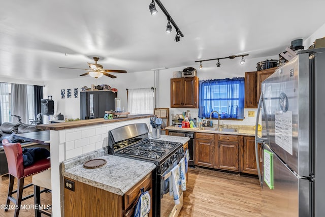23 Vought Ave, Freehold, NJ 07728 - kitchen featuring gas range, a sink, freestanding refrigerator, light countertops, and open floor plan