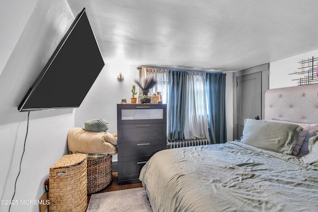 23 Vought Ave, Freehold, NJ 07728 - bedroom with light wood-style floors and radiator heating unit