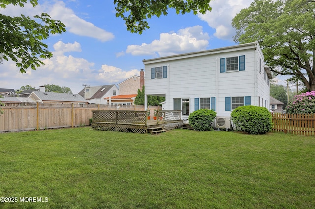 rear view of house with a wooden deck and a cooling unit