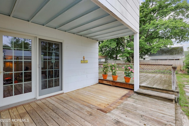 wooden terrace featuring fence