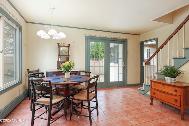 dining space with stairs, a chandelier, light tile patterned flooring, crown molding, and baseboards