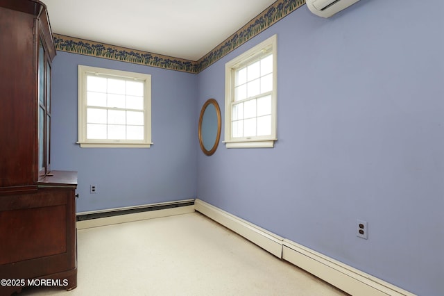 unfurnished room featuring a baseboard radiator, a wall unit AC, and baseboards
