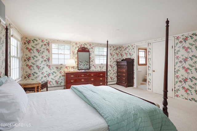 carpeted bedroom with wallpapered walls and a baseboard radiator