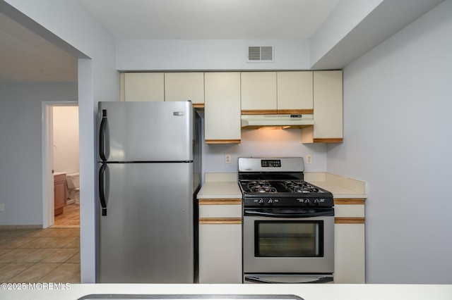 270 Main St Unit 6, Keansburg, NJ 07734 - kitchen with appliances with stainless steel finishes, under cabinet range hood, cream cabinets, and light countertops
