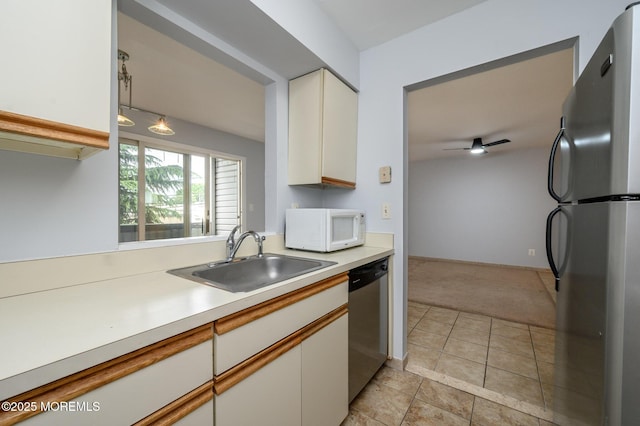 270 Main St Unit 6, Keansburg, NJ 07734 - kitchen with stainless steel appliances, a sink, light carpet, light countertops, and white cabinetry