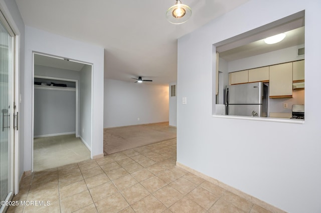 270 Main St Unit 6, Keansburg, NJ 07734 - kitchen featuring freestanding refrigerator, light colored carpet, cream cabinetry, light tile patterned floors, and a ceiling fan