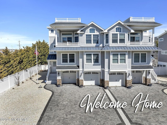 5 E 44th St Unit 1, Long Beach Twp, NJ 08008 - view of front facade featuring a standing seam roof, a balcony, fence, and an attached garage