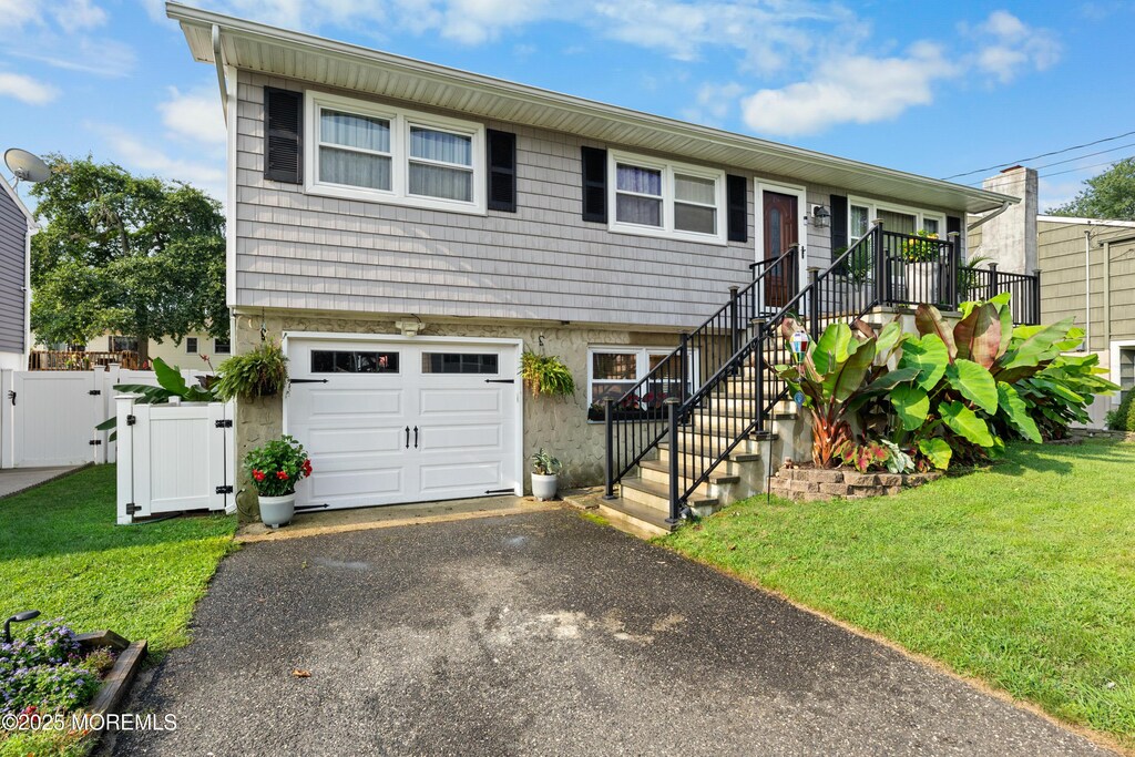 2118 Kenneth Rd, Point Pleasant, NJ 08742 - view of front of home featuring a garage, a gate, driveway, and stairs