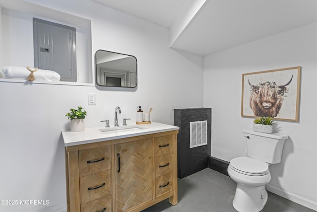 bathroom featuring electric panel, toilet, vanity, and baseboards