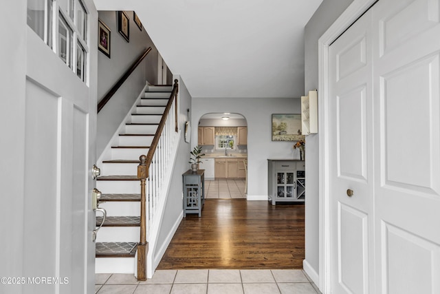 2124 3rd Ave, Toms River, NJ 08757 - entryway featuring light tile patterned floors, arched walkways, stairway, and baseboards