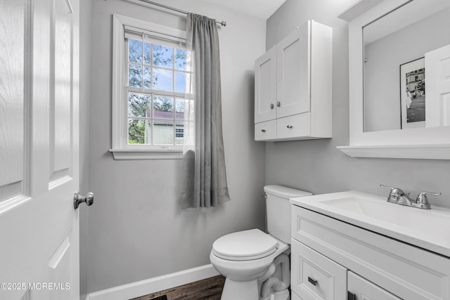 2124 3rd Ave, Toms River, NJ 08757 - bathroom featuring toilet, vanity, wood finished floors, and baseboards