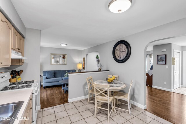 2124 3rd Ave, Toms River, NJ 08757 - dining area featuring arched walkways, light tile patterned flooring, and baseboards