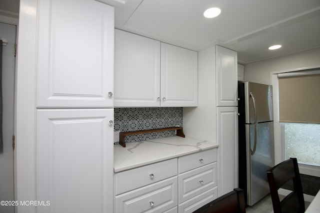 41 Eagle Dr, Whiting, NJ 08759 - kitchen with freestanding refrigerator, white cabinets, decorative backsplash, light stone countertops, and recessed lighting