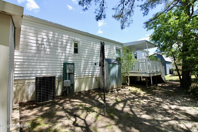 41 Eagle Dr, Whiting, NJ 08759 - rear view of property with central AC unit and a deck