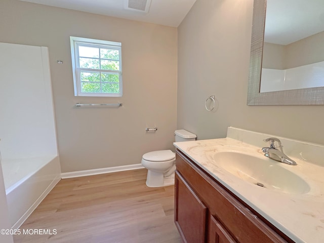 143 2nd Ave, Toms River, NJ 08757 - bathroom with wood finished floors, toilet, vanity, a bathtub, and baseboards