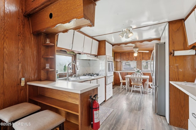 220 W Sylvania Ave Unit 16, Neptune City, NJ 07753 - kitchen featuring open shelves, freestanding refrigerator, under cabinet range hood, and ceiling fan