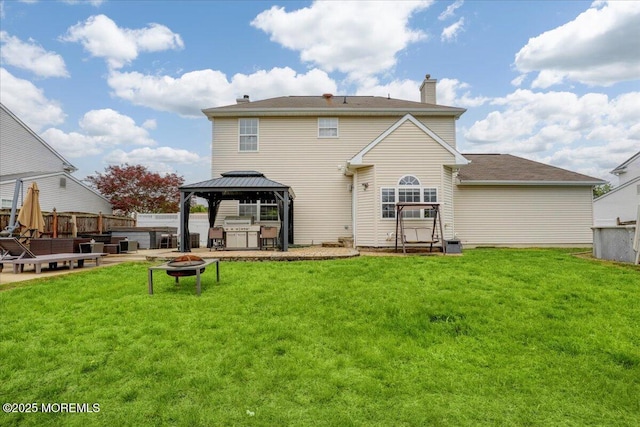 back of house featuring an outdoor fire pit, a gazebo, a chimney, and a patio area