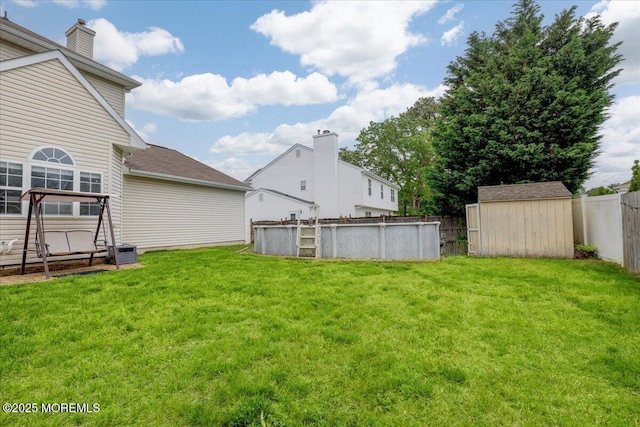 view of yard with a shed and an outbuilding