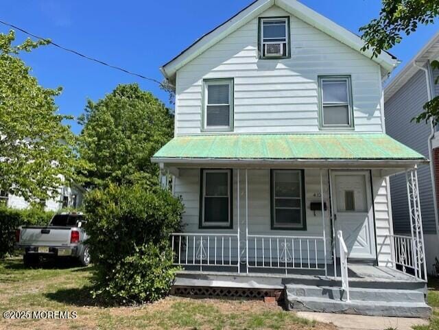 view of front of home with covered porch and metal roof