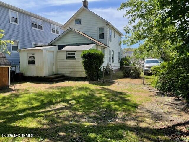 back of property with a chimney