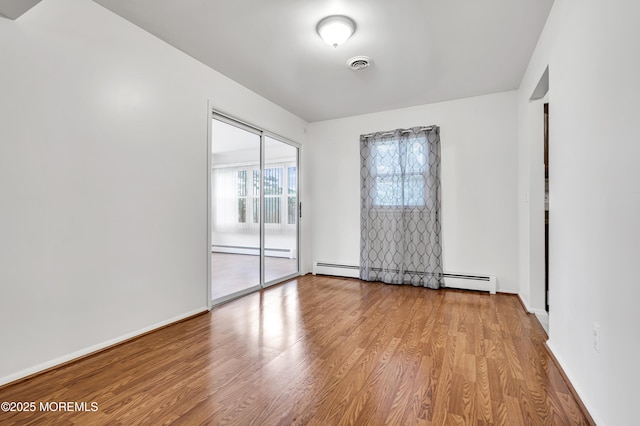 32 Bugle Ct, Toms River, NJ 08757 - spare room featuring wood finished floors, a baseboard radiator, and baseboards